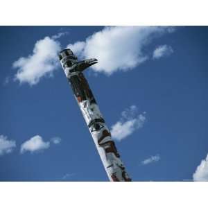  Indian Totem Pole against Blue Sky with Puffy White Clouds 